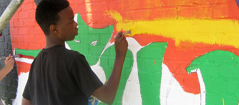 Students painting a classroom mural